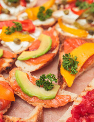 Catering table, beautifully decorated banquet with variety of with different food snacks and appetizers on corporate birthday party event or wedding celebration, delicatessen setting