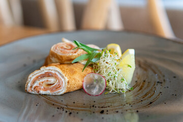 Pancakes with red fish lemon and herbs