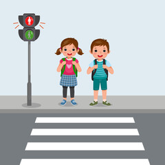 Cute School kids with backpack waiting stop sign on pedestrian traffic light to cross road on zebra crossing on way to school - obrazy, fototapety, plakaty