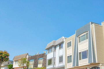 Low angle view of suburban houses with wood vinyl and shingle sidings at San Francisco, California