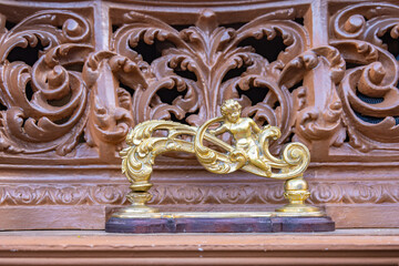 Detail of golden knocker (llamador) in the form of an Angel in a paso (platform or throne) of the Holy Week in procession
