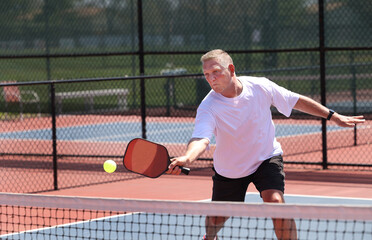pickleball is being played by senior male.