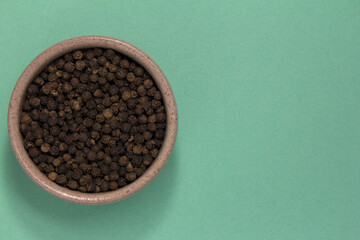 Not ground pepper. Place for text. On a turquoise background.