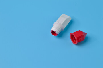 Red watercolor isolated on a blue background. Copy space for the text