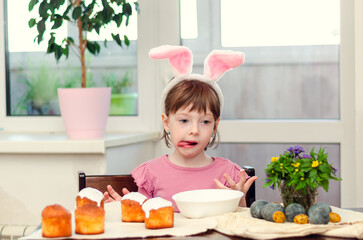 The girl decorates Easter cakes.  Easter preparations.