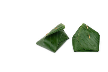 Thai dessert made from sticky rice wrapped in banana leaves isolated on white background, Custard dessert