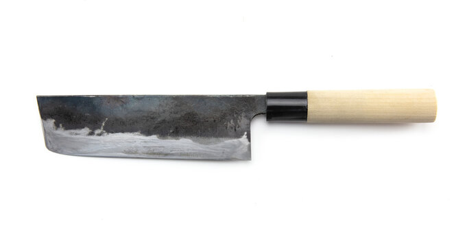 Nakiri knife isolated on white. Hand forged traditional Asian green or vegetable cutting knife with really sharpened blade with blackened sides. 