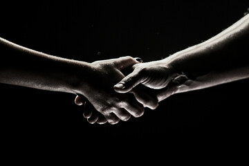 Hands gesturing on black background. Giving a helping hand. Support and help, agreement. Hands of...
