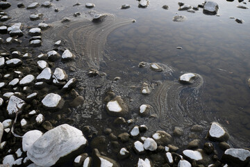 The frozen river with cobblestones