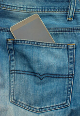Modern mobile phone in a denim pocket