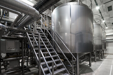Metal steps near huge tanks for fermented milk products