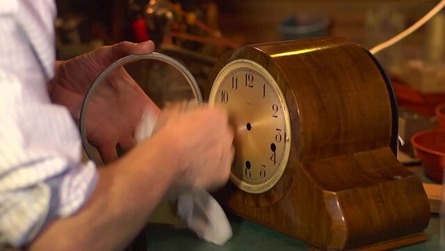 Clockmaker cleaning a clock which has just been restored.