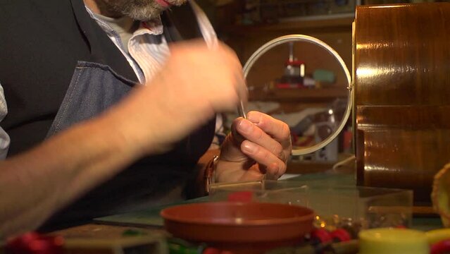 Clockmaker using a needle file, close up.
