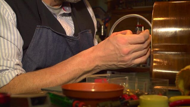 Clockmaker fitting hands to a clock, close up