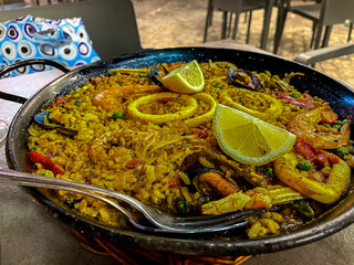 Delicious Original Paella Valenciana in the Playa Mayor of Spain