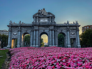 Beautiful view of the iconic (Puerta de alcala) alcala gate in spring, cover in flowers on a sunset 