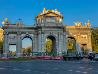 Beautiful view of the iconic (Puerta de alcala) alcala gate in spring, cover in flowers on a sunset 