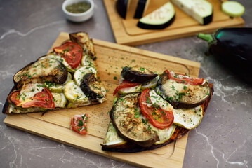 Delicious vegetarian pizza on wooden board.