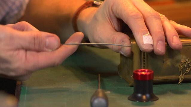 Clockmaker opening the case of an old carriage clock