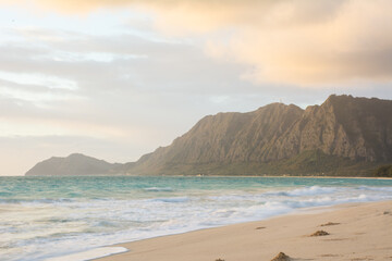 Morning sunrise at Waimanalo beach near Bellows on the windward side of Oahu in Hawaii with Koolau mountains in background.