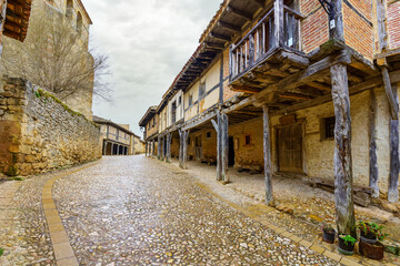 Medieval wooden arcades and balconies hanging in Calatanazor, Spain.