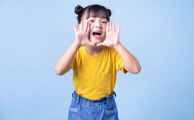 Image of Asian child posing on blue background