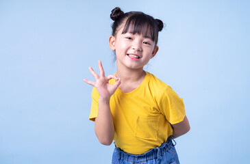 Image of Asian child posing on blue background