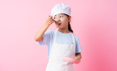 Image of Asian child practicing to be a chef