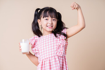 Image of Asian child drinking milk on background