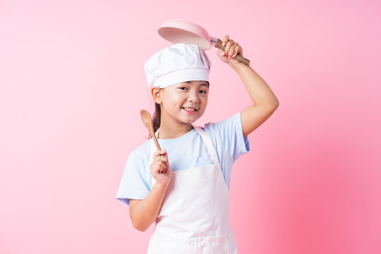 Image of Asian child practicing to be a chef