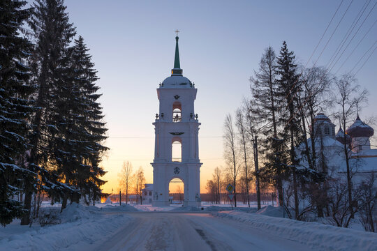 Ancient bell tower against the backdrop of a winter dawn. Cathedral Square in Kargopol. Arkhangelsk region, Russia