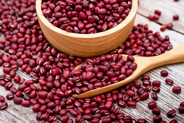Red small Azuki beans (Adzuki or japanese red bean in wooden bowl isolated on wood table background.
