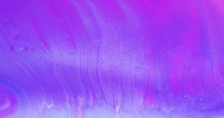 Floating paint. Iridescent background. Ink water mix. Defocused neon purple blue pink color bubble...
