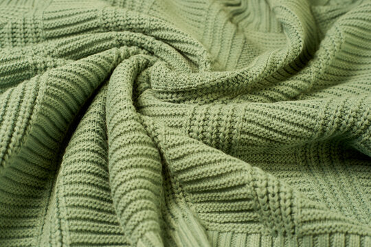 Green Knitted Fabric Is Gathered In Folds, Large Knitted Sweaters