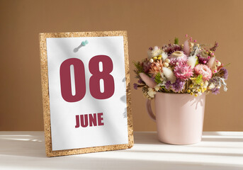 june 8. 8th day of month, calendar date.Bouquet of dead wood in pink mug on desktop.Cork board with calendar sheet on white-beige background. Concept of day of year, time planner, summer month
