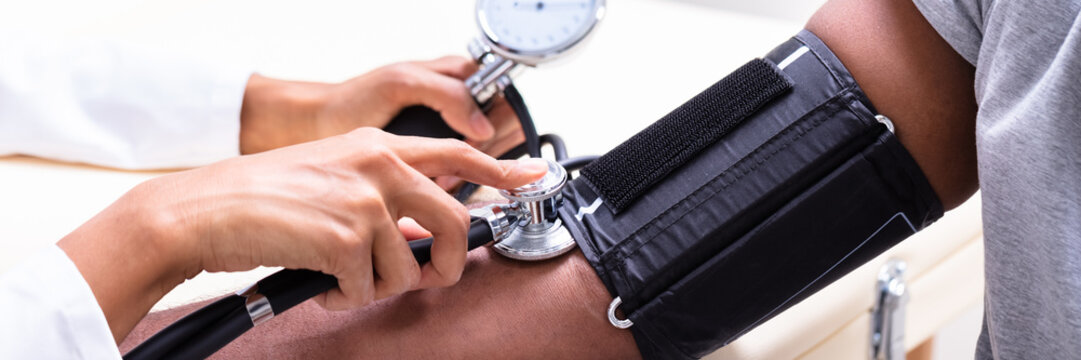 Young Doctor Checking Blood Pressure