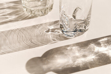 Trendy pattern made with glasses and shadows. glass with sparkling sunlight shadow on the neutral...