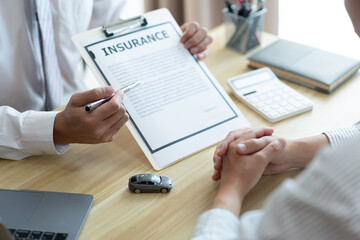 Insurance concept the auto dealer emphasizing on the agreement of the contract for his client
