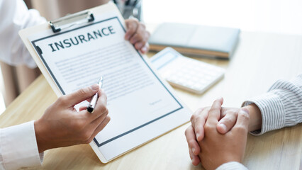 Insurance concept the auto dealer emphasizing on the agreement of the contract for his client