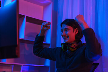 Gamer stream concept, Male streamer having happiness after live streaming of winning game tournament