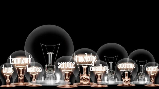 Light bulbs going from dark to light with Expertise, Advice, Research, Teamwork and Knowledge fiber text on black background. High quality 4k video.