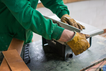 Unrecognizable Man working And Cutting The Wood On A Machine Tool Called A Table Saw In A Carpentry Workshop. Person Doing DIY In The Garden Of His House. DIY And Craft Concept. Detail