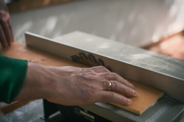 Hands Of A Man Making Custom Furniture Wood Parts On Machine Tool Called Table Saw In Woodworking...