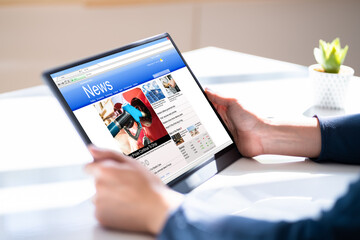 Reading Newspaper Article On Tablet