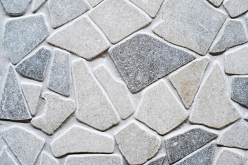 Fragment of a gray wall made of decorative stone. Facing material of various shapes and sizes. flat lay frame