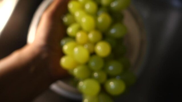 Slow motion of hand washing grape