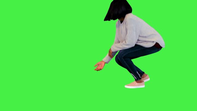 Cute girl playing with border collie throwing a ball on a Green Screen, Chroma Key.
