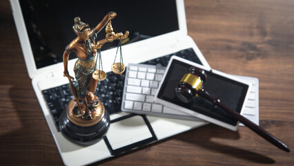 Lady Justice Statue with a judge gavel, tablet and computer.