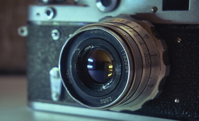 Film camera unknown model. Manual object. In the background is a leather case of cabura