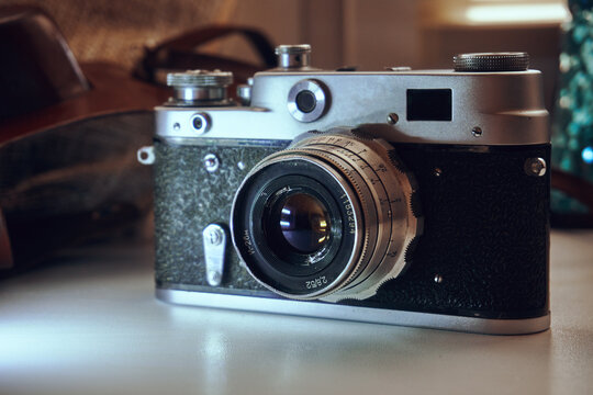 Film camera unknown model. Manual object. In the background is a leather case of cabura
